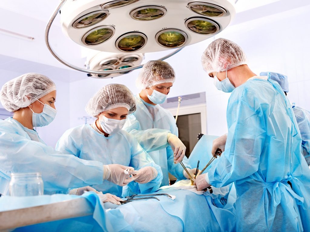 Team surgeon at work in operating room.